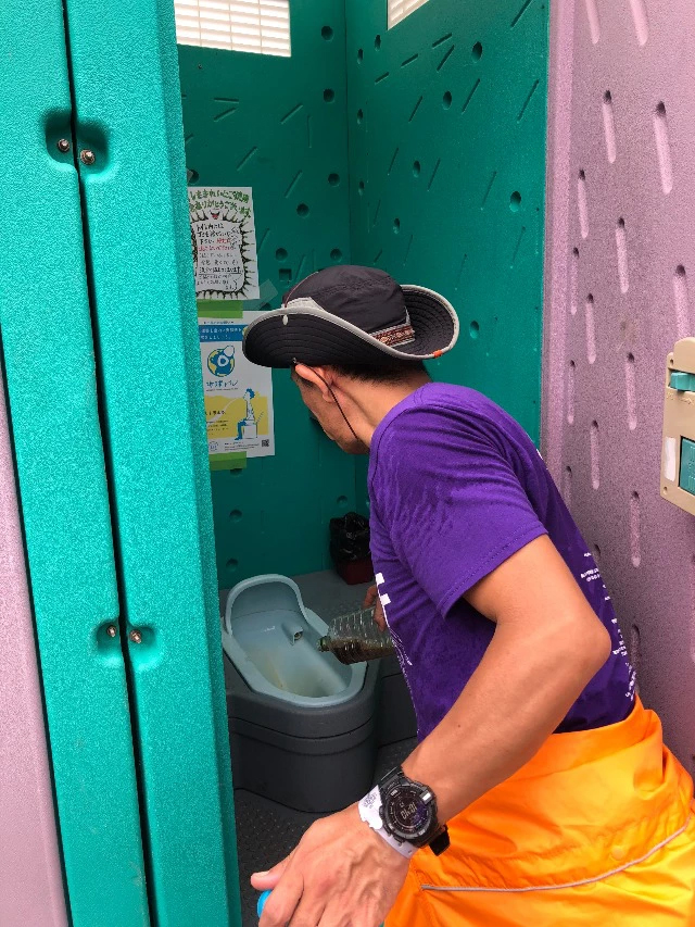 Staff cleaning the toilet with EM