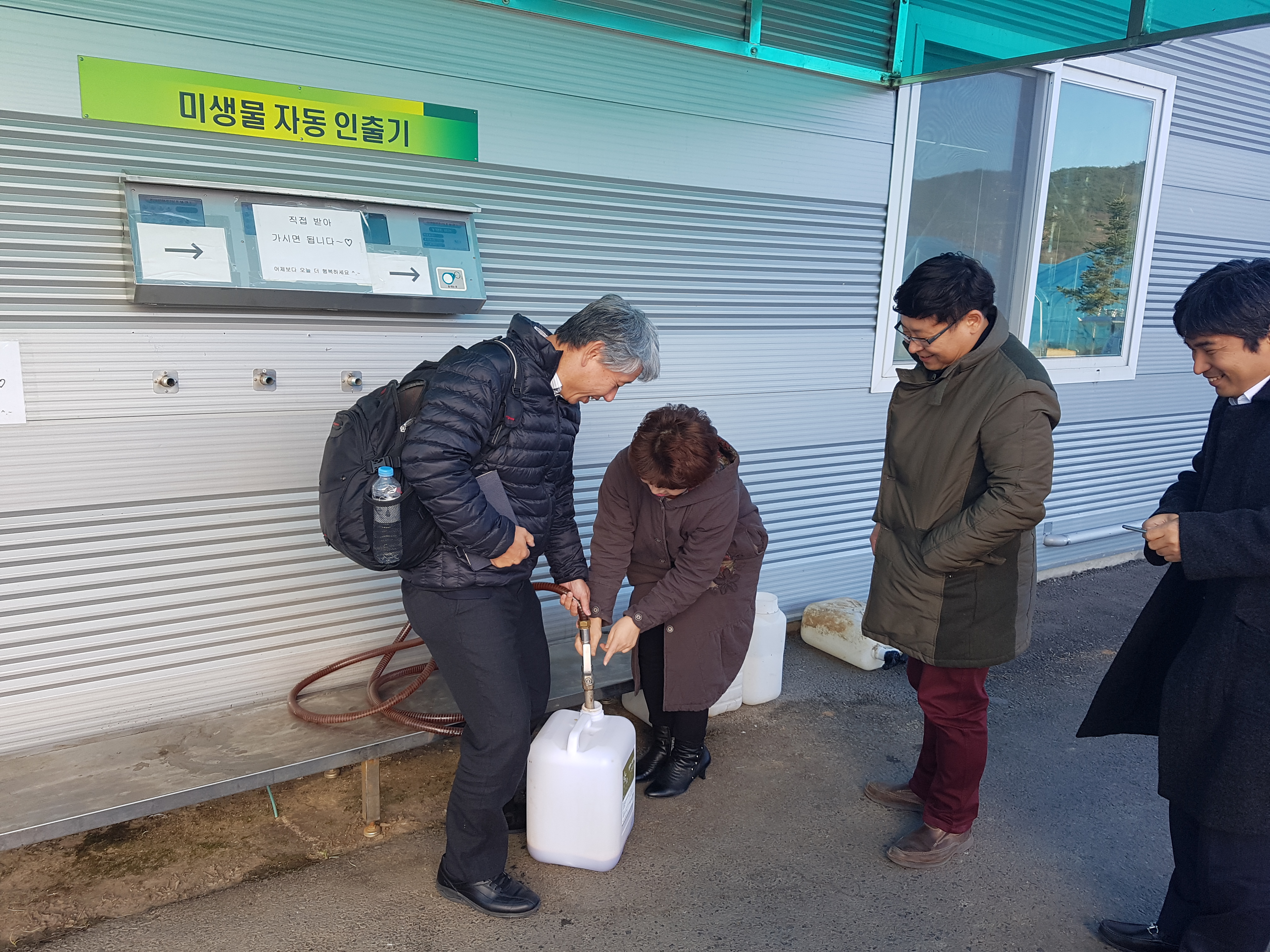 Filling the plastic container with AEM at the EM dispenser