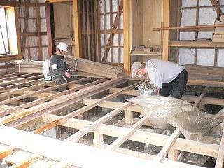 Volunteers spraying Activated EM・1® under floors, surroundings and on garbage from a seaweed factory